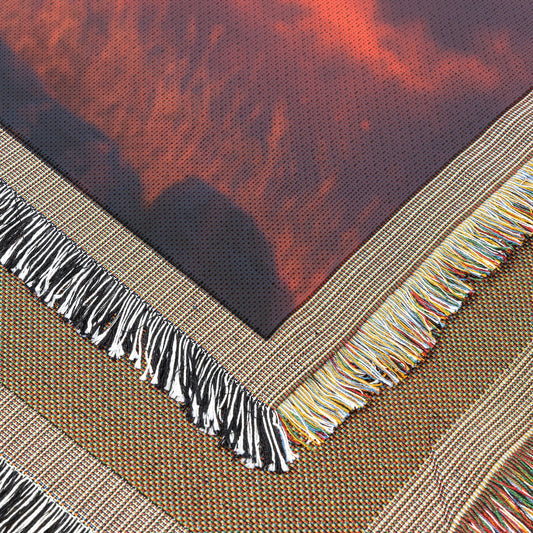 Majestic Lion on Rocky Savanna Ridge Under Glowing Red and Orange Sunset with Illuminated Golden Mane Woven Throw Blanket - Awakening Righteousness
