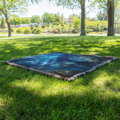 Blue Whale Resting Peacefully in Glowing Deep Sea Cave Surrounded by Bioluminescent Plants and Soft Ethereal Light Woven Throw Blanket - Awakening Righteousness