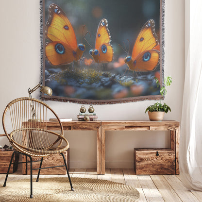 Three Vibrant Orange Butterflies with Blue Eyes on Mossy Rocks Surrounded by Flowers Cozy Woven Throw Blanket - Awakening Righteousness