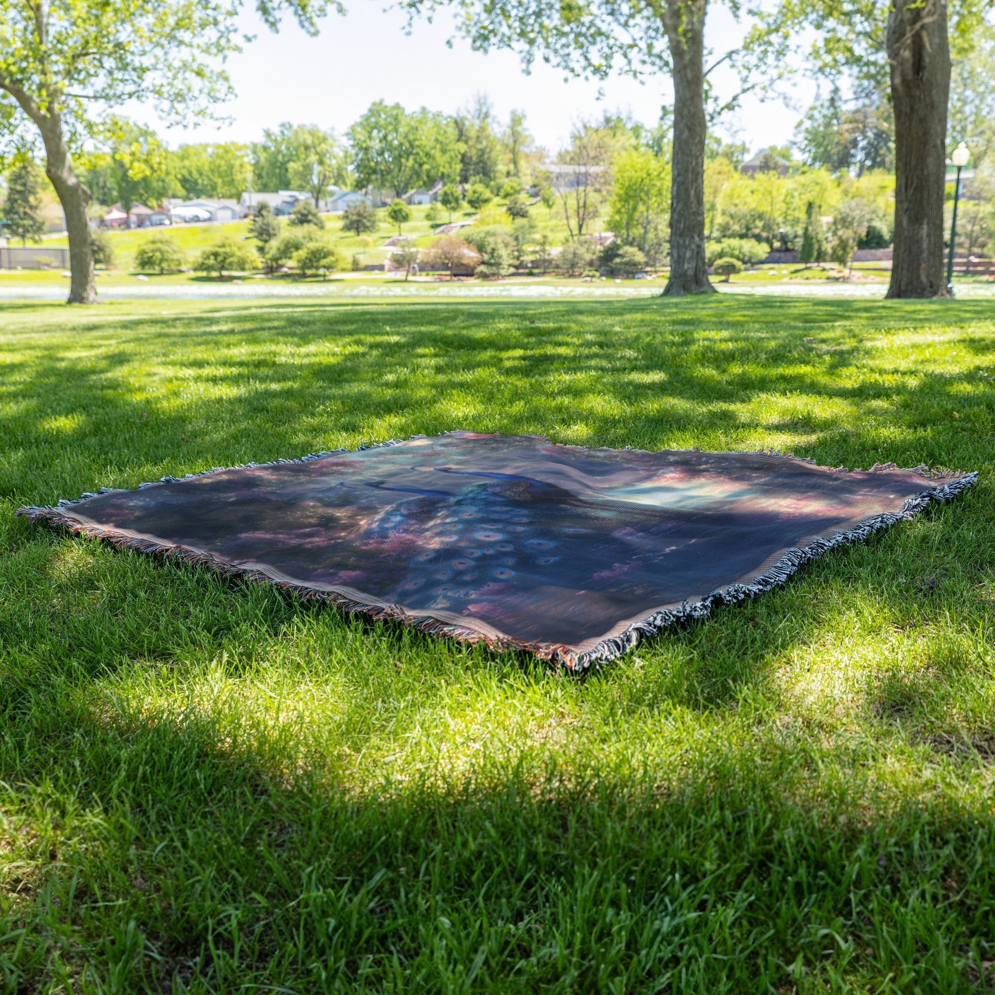 Two Peacocks by Glowing River with Lush Greenery and Vibrant Flowers Under Twilight Light Woven Throw Blanket - Awakening Righteousness