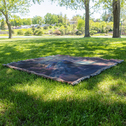 Two Peacocks by Glowing River with Lush Greenery and Vibrant Flowers Under Twilight Light Woven Throw Blanket - Awakening Righteousness
